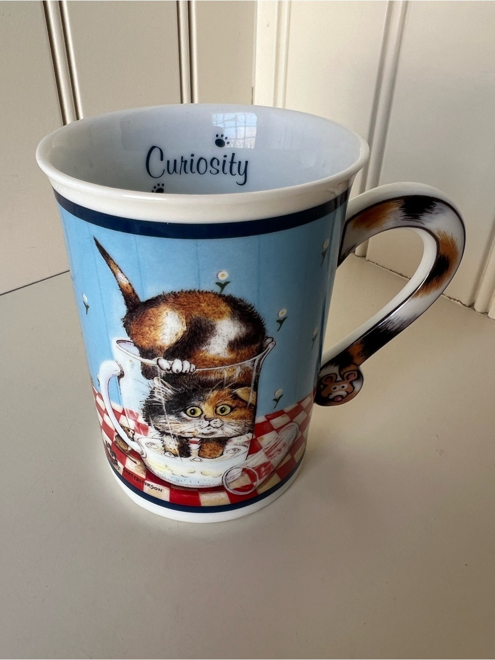 Curiosity Cat Blue Ceramic Mug by Gary Patterson